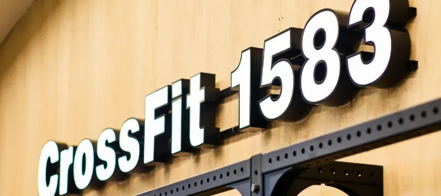 Image of Crossfit 1583 light box sign on wooden wall