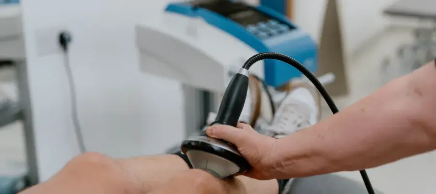 Shockwave therapy machine being used on knee