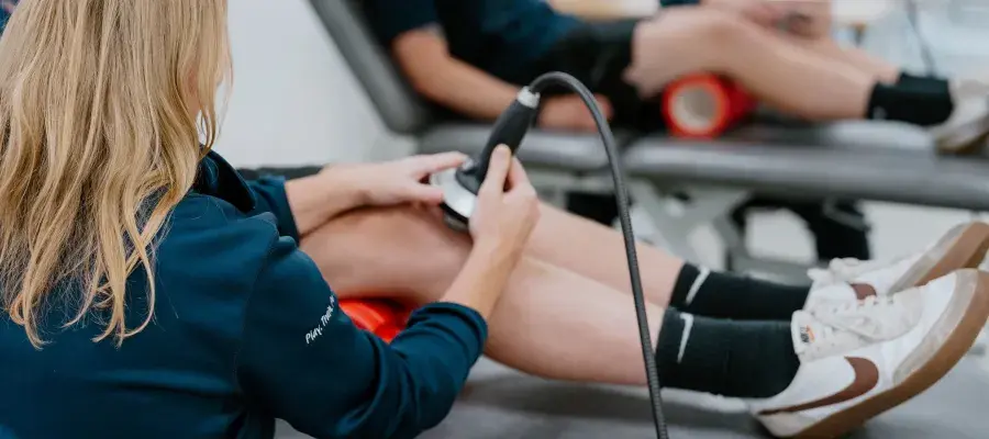 person getting shockwave therapy on knee