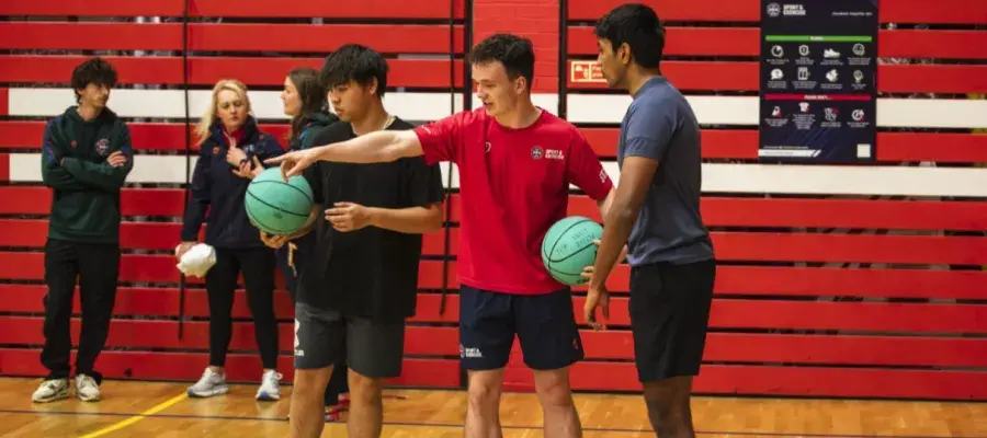 person explaining basketball rules to 2 people