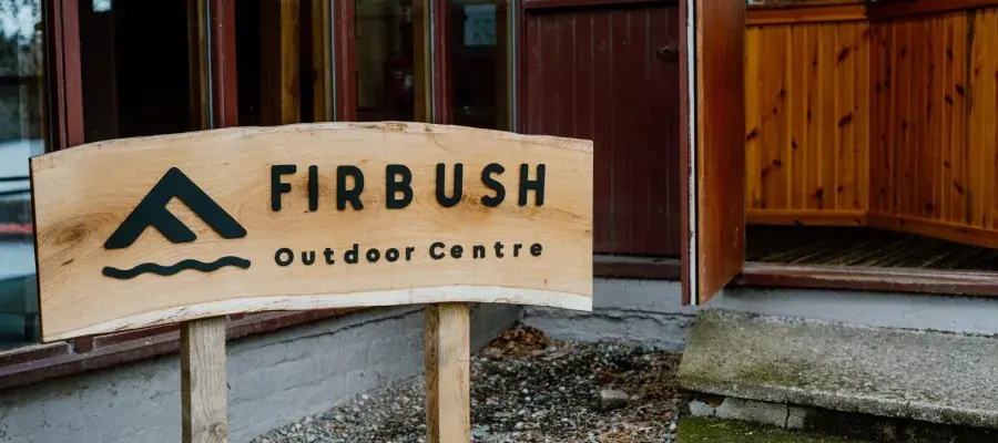 Wood sign saying Firbush Outdoor Centre
