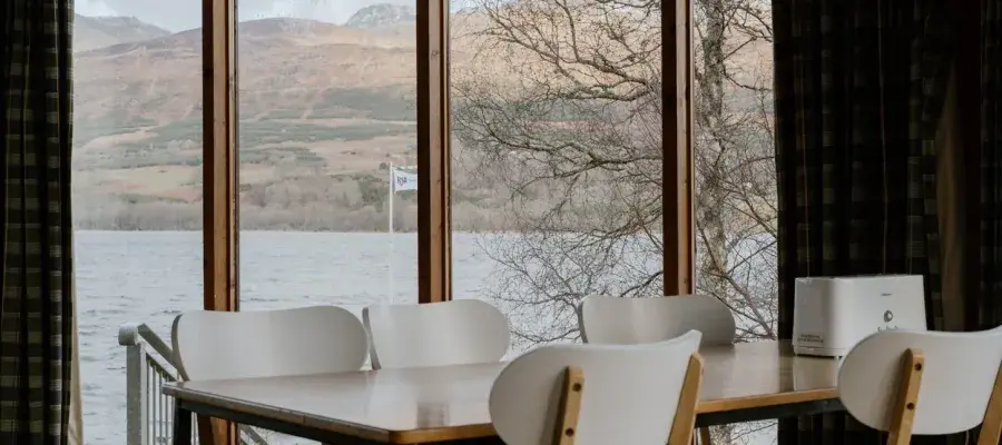 chairs infront of a big window looking at over a loch
