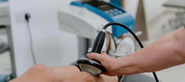 Shockwave therapy machine being used on knee