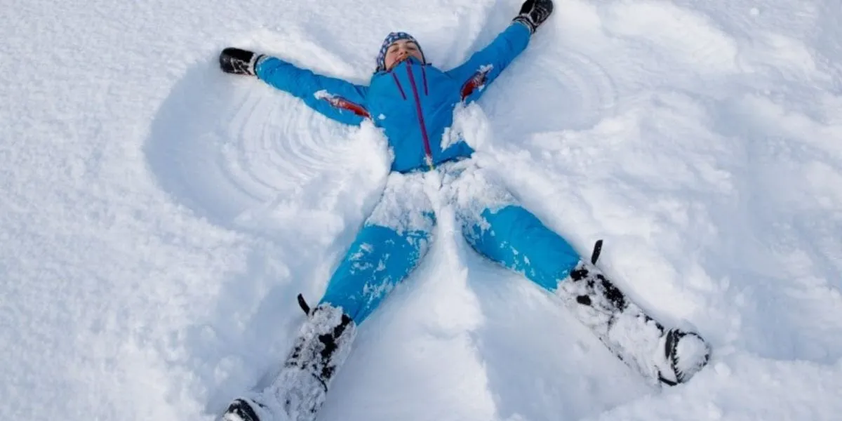 Girl doing a snow angel in the snow