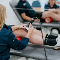 person getting shockwave therapy on knee