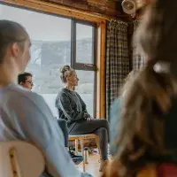 Wellbeing session, people sat in a circle in wooden room