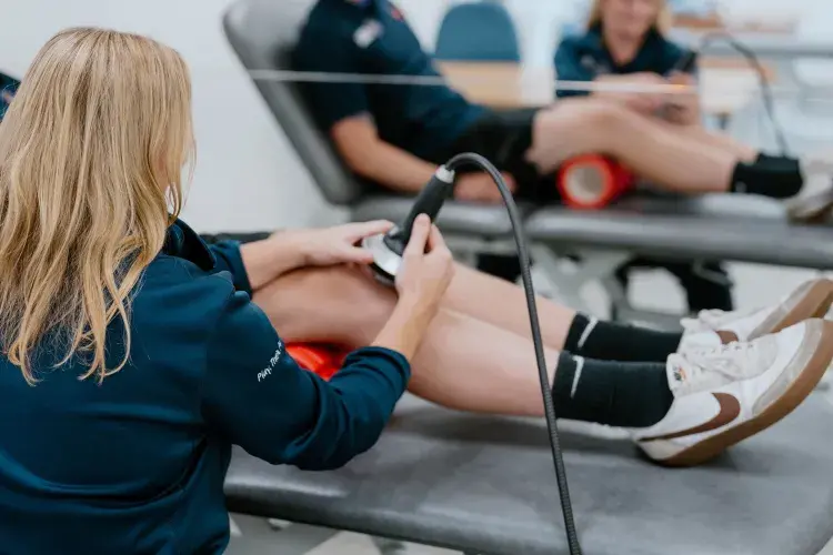 person getting shockwave therapy on knee