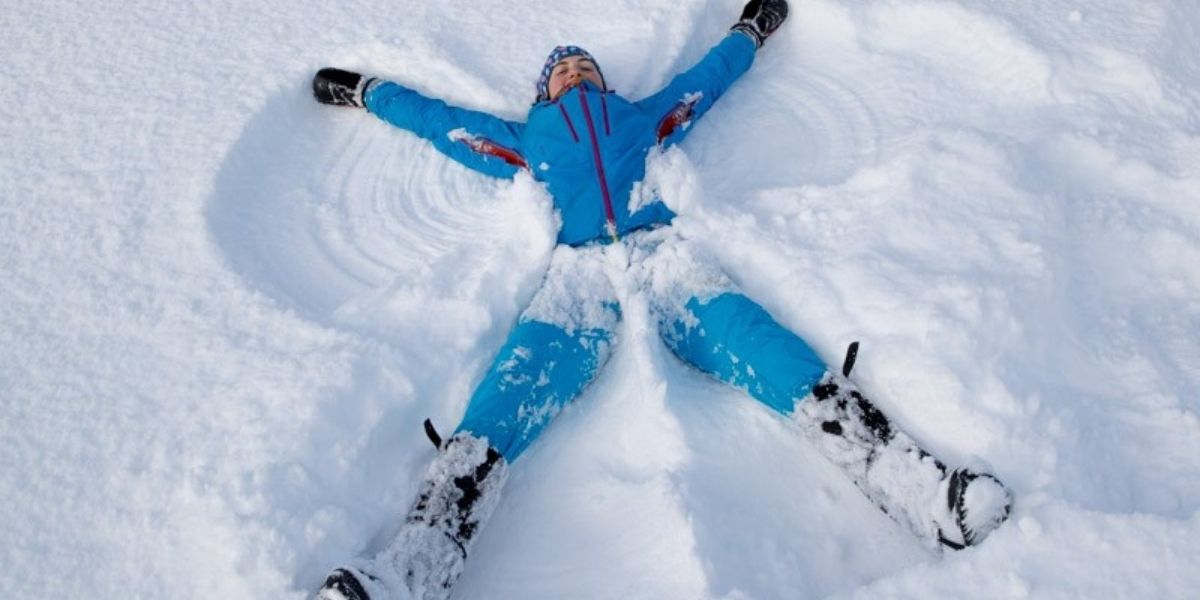 Firbush - individuals Girl doing a snow angel in the snow